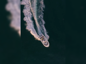 Aerial view of a sleek speedboat cutting through the water, showcasing its dynamic movement and design — perfect for thrilling water adventures.