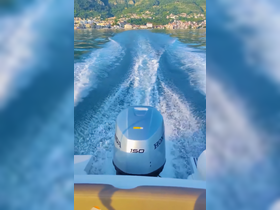 A sleek view of a Honda outboard motor in action, leaving a wake on tranquil waters, showcasing the beauty of boating adventures.