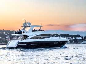 A stunning yacht glides through the water at sunset, showcasing its elegant design and luxurious features — perfect for upscale boating experiences.