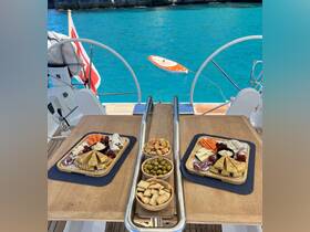 A beautifully arranged charcuterie spread featuring a variety of snacks and fruits, perfect for enjoying on a yacht while soaking in the stunning turquoise waters.