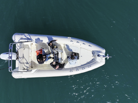 Aerial view of a group enjoying time aboard a boat, showcasing camaraderie and on-water activities in a vibrant setting.