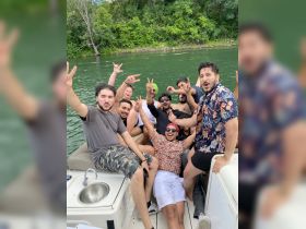 A lively group of friends celebrates on a boat, enjoying a fun day out on the water — perfect for summer parties and memorable gatherings.