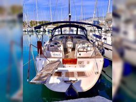 A stunning view of the 'Venus' yacht docked at the marina, showcasing its sleek design and inviting deck, perfect for sailing adventures.