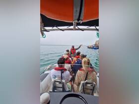 A lively group aboard a boat listens to a guide, ready for an exciting ocean adventure. Perfect for those seeking memorable boat tours and experiences.