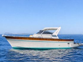 A sleek yacht glides through clear waters, showcasing its elegant design and perfect for luxury outings on the sea.