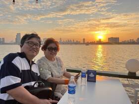 A couple enjoys a picturesque sunset on a boat, creating a perfect backdrop for romantic moments and celebrations on the water.