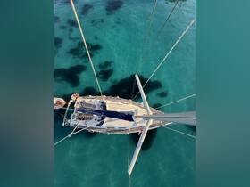 A stunning aerial view of a sailboat gliding over crystal-clear waters, showcasing the beauty of sailing adventures in tropical destinations.