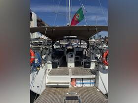 Interior view of a well-equipped sailboat, showcasing the helm and seating area, perfect for comfortable cruising and relaxation on the water.