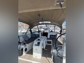 Interior view of a sleek sailboat's helm and seating area, showcasing modern design and comfort for an enjoyable sailing experience.