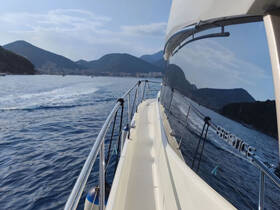 A stunning view of a yacht cruising through calm waters, showcasing the sleek design and beautiful surroundings of the coastline.
