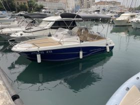A sleek center console boat docked in a marina, showcasing its stylish design and inviting seating area — perfect for day trips on the water.