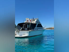 A stunning view of the Nautilus yacht anchored in crystal-clear waters, showcasing its elegant design against a backdrop of blue skies.