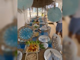 A beautifully arranged dining table onboard, featuring a variety of fresh dishes and drinks, perfect for enjoying meals while cruising on the water.