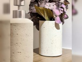 A close-up view of decorative items, including a textured vase and flowers, showcasing modern interior design elements.