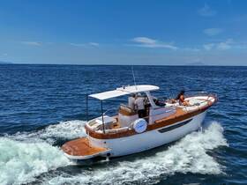 A stylish yacht glides through the sparkling waters with guests enjoying the sunny day — perfect for a memorable boating experience.