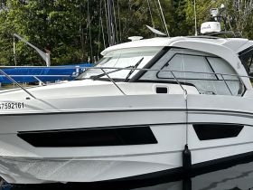 A close-up view of a sleek yacht docked at the marina, showcasing its elegant design and features.