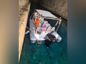 A sleek speedboat docked in a serene canal, showcasing its modern design and clear waters below.