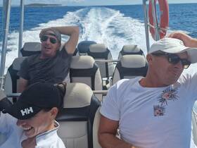 A group of friends enjoys a thrilling ride on a boat, capturing the essence of fun and adventure on the water.