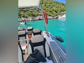 A view of the interior seating area of a boat, showcasing comfortable seats and a scenic turquoise backdrop. Perfect for relaxing while enjoying a day on the water.