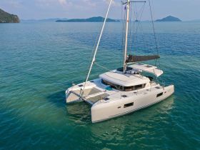 A stunning aerial view of a sleek catamaran gliding through crystal-clear waters, perfect for exploring tropical destinations.