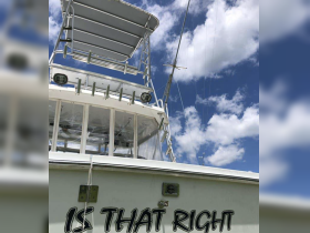 A close-up view of the front of a fishing boat named 'IS THAT RIGHT,' showcasing its structure against a backdrop of blue skies and clouds.