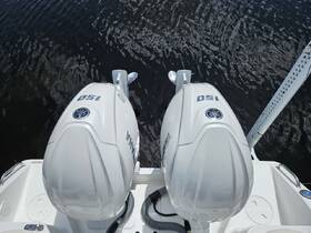 Close-up view of twin Yamaha 150 outboard engines on a boat, showcasing essential amenities for power and performance on the water.