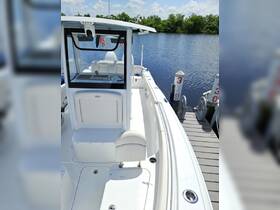 A clean and spacious interior view of a boat's helm and seating area, showcasing the modern design and amenities for a comfortable boating experience.