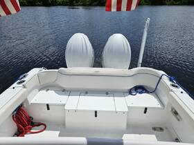 Interior view of a boat's seating area, showcasing a clean and spacious helm with ample storage — perfect for comfortable outings on the water.