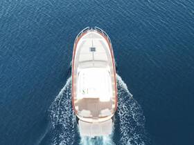 Aerial view of a sleek boat cruising through deep blue waters, showcasing its elegant design and smooth movement.