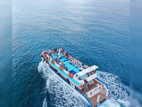 A lively group enjoys a cruise on the Blue Lagoon, surrounded by stunning ocean views — perfect for a fun day on the water.