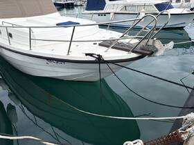 A close-up view of a yacht named 'ENJOY' docked in calm waters, showcasing its sleek design and tranquil marina setting.