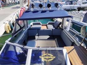 A well-appointed interior view of a Sunseeker boat, showcasing comfortable seating and a stylish cabin design, perfect for relaxing on the water.