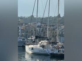 A serene view of a yacht docked in a marina, surrounded by picturesque buildings and calm waters, perfect for a relaxing day on the water.
