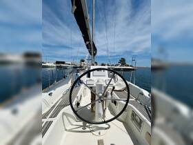 A detailed view of the helm and console area inside a sailboat, showcasing the steering wheel and navigational equipment, perfect for sailing enthusiasts.