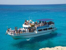 A lively group enjoys a day on the water aboard the Santa Napa, surrounded by stunning turquoise seas — perfect for sun-soaked adventures and memorable boat trips.