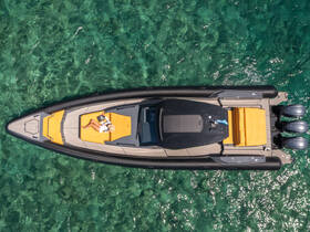Aerial view of a person relaxing on the deck of a sleek boat, surrounded by crystal-clear waters — an ideal scene for sunbathing and enjoying the summer vibes.