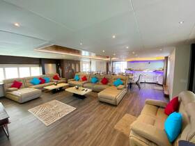 Spacious and stylish interior of a boat featuring comfortable seating and a modern lounge area, perfect for relaxing during your nautical adventures.