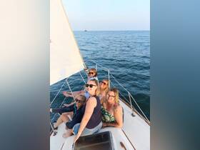 A joyful group of friends enjoys a sailing adventure, capturing smiles and camaraderie on the open water — perfect for memorable outings and celebrations.