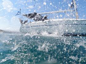 A dynamic shot capturing the splashes of water as a sailboat navigates through the ocean, showcasing the thrill of sailing adventures.