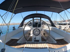A well-appointed helm area of a sailboat, featuring comfortable seating and a modern console, ideal for navigating the open waters.