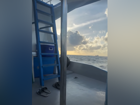 An interior view of a boat showcasing a ladder, cooler, and seating area, perfect for relaxing while enjoying the ocean breeze.