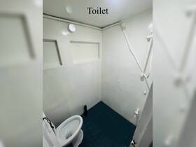 Interior view of a boat's toilet, showcasing the compact and functional design typical of marine bathrooms.