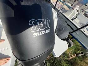 Close-up of a Suzuki 250 engine on a boat, showcasing essential onboard equipment for marine adventures.