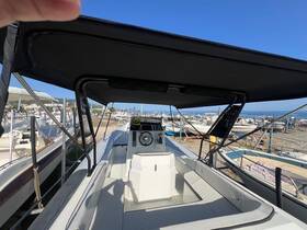 A view of the helm area inside a boat, showcasing the console and seating, perfect for navigating the waters.