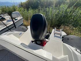 A detailed view of the boat's helm area, showcasing the console and engine, ideal for understanding the vessel's layout and features.