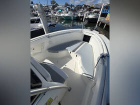 A clean and spacious interior view of a boat's helm and seating area, showcasing the perfect setup for a comfortable day on the water.
