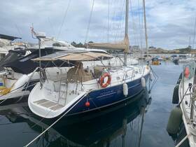 A sleek OCEANIS 411 yacht docked in a marina, showcasing its elegant design and tranquil surroundings — perfect for sailing enthusiasts.