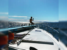 A person captures the stunning ocean view from the bow of a boat, highlighting the beauty of a day on the water.