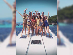 A lively group of friends celebrates summer on the deck of a boat, showcasing the perfect atmosphere for fun and adventure on the water.