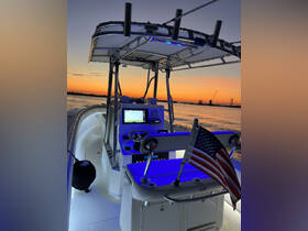 A well-equipped helm of a boat featuring modern navigation tools and ambient lighting, perfect for evening cruises on the water.